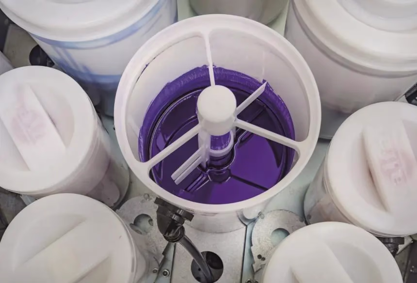Toner canister with built-in stirring paddle inside an Alfa dispenser